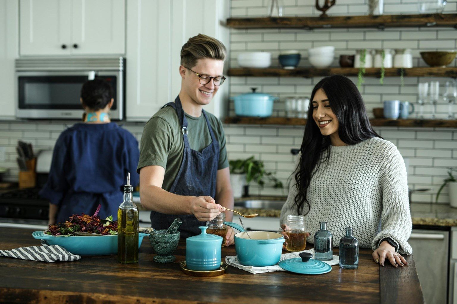 Neighbors cooking together in a shared community kitchen