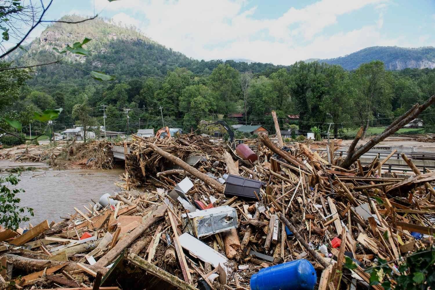 Storm debris piled along a river in the Appalachian mountains after Hurricane Helene